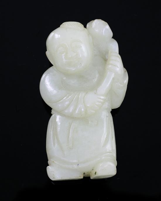 A Chinese pale greenish-yellow jade figure of a boy holding a sprig of lotus, 18th/19th century, 5.9cm